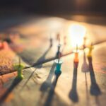 Blurred world map with colourful pins turned upside down